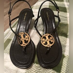 Never worn Tory Burch black thong sandals with gold emblem size 7.5.